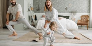 A joyful family engaging in morning stretches together, fostering a fun and healthy routine.